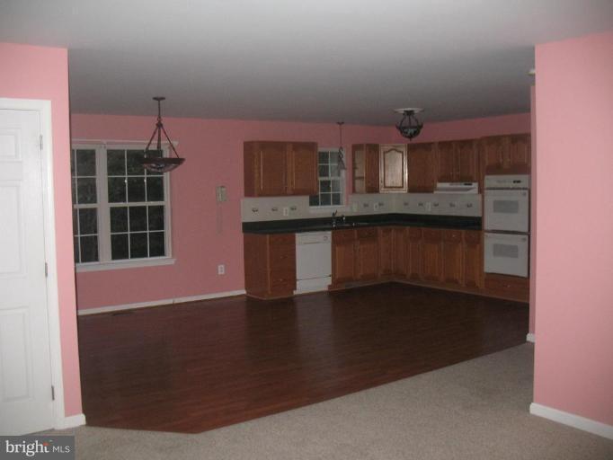225 Barstow Road Prince Frederick, MD 20678 - Photo 2 of 10 a front view of a house with wooden floor