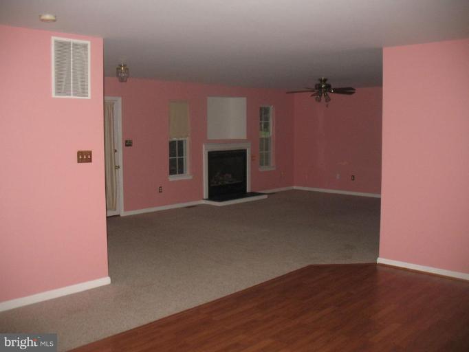 225 Barstow Road Prince Frederick, MD 20678 - Photo 4 of 10 a view of empty room with a fireplace