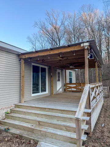 a view of house with outdoor space and porch