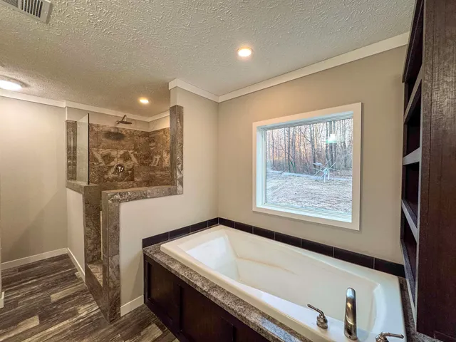 a bathroom with a bathtub and a window