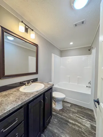 a bathroom with a granite countertop sink toilet and a bathtub