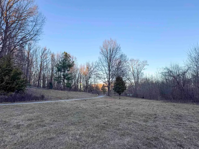 a view of dirt yard with a house