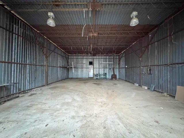 a view of empty room with wooden walls