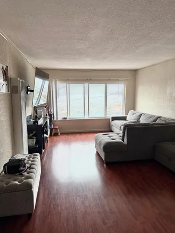 a living room with furniture and a large window