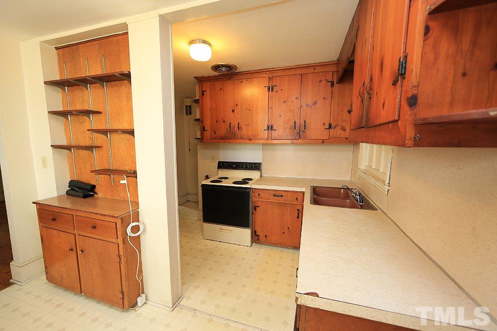 206 South Pettigrew Street Raleigh, NC 27610 - Photo 6 of 13 a kitchen with stainless steel appliances granite countertop a stove a sink and a refrigerator