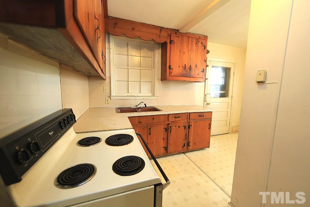 206 South Pettigrew Street Raleigh, NC 27610 - Photo 7 of 13 a bathroom with a sink and a washing machine
