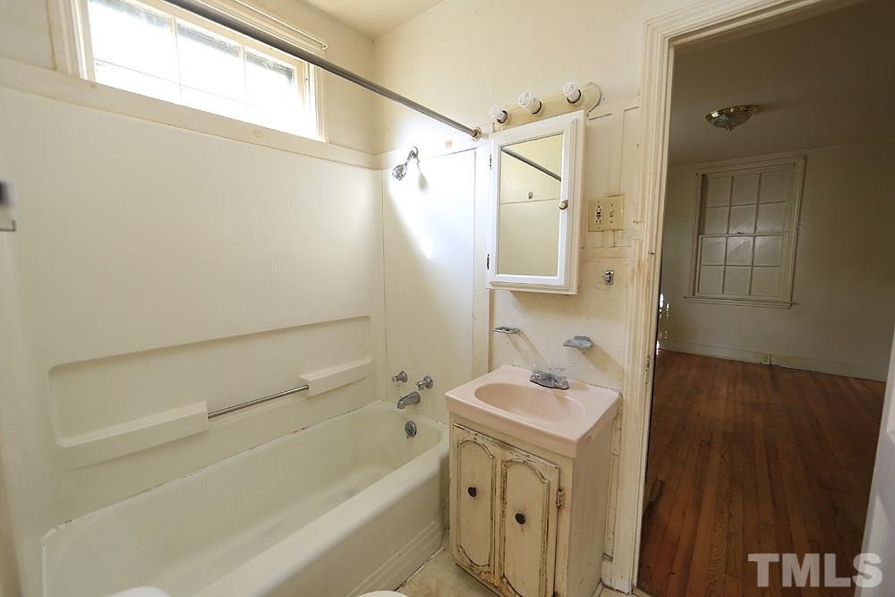 206 South Pettigrew Street Raleigh, NC 27610 - Photo 9 of 13 a bathroom with a sink a toilet and shower