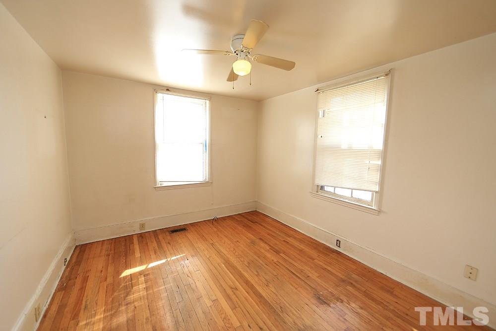 206 South Pettigrew Street Raleigh, NC 27610 - Photo 10 of 13 a view of an empty room with wooden floor and a window
