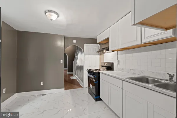 a kitchen with a sink cabinets and appliances