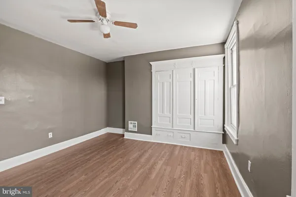 wooden floor in an empty room with a window
