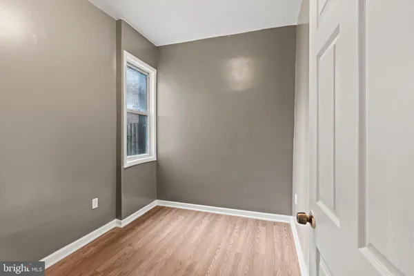 a view of room with window and hardwood floor