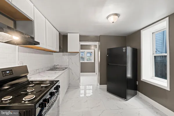 a kitchen with a stove and a refrigerator