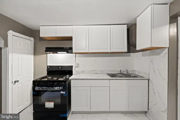 a kitchen with stainless steel appliances granite countertop a sink stove and microwave