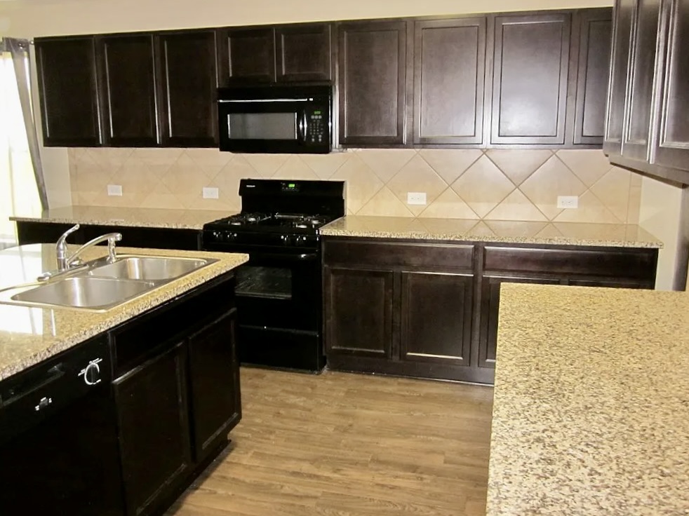 541 Alpha Kyle, TX 78640 - Photo 4 of 9 An inviting culinary space with rich cabinetry and ample counter surfaces for preparing meals.