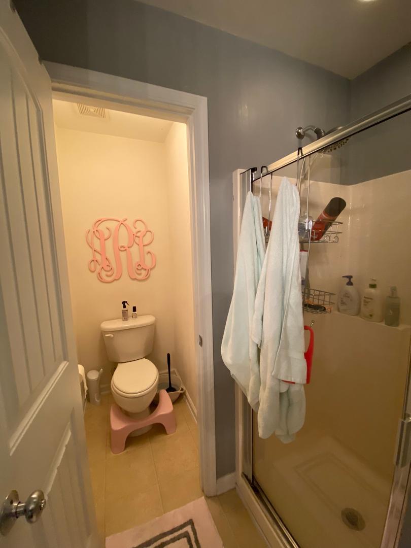 4646 Altha Street Raleigh, NC 27606 - Photo 14 of 23 a bathroom with a sink toilet and shower