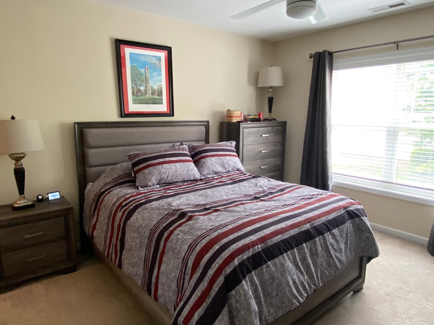 4646 Altha Street Raleigh, NC 27606 - Photo 18 of 23 a bedroom with a bed and a window