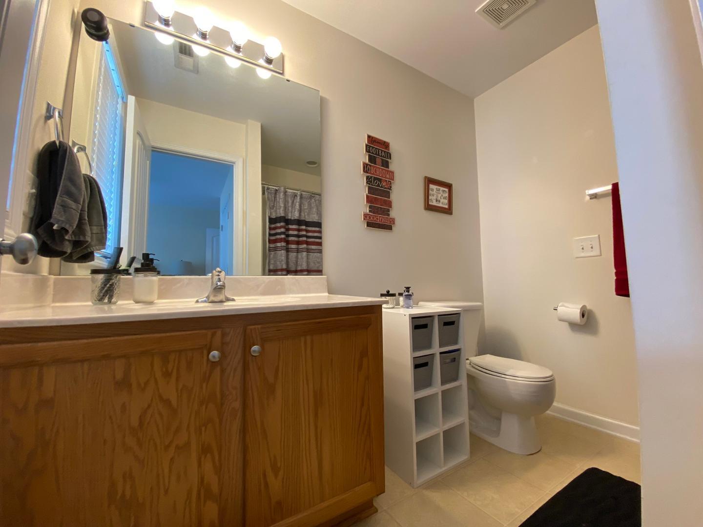 4646 Altha Street Raleigh, NC 27606 - Photo 19 of 23 a bathroom with a sink and a mirror