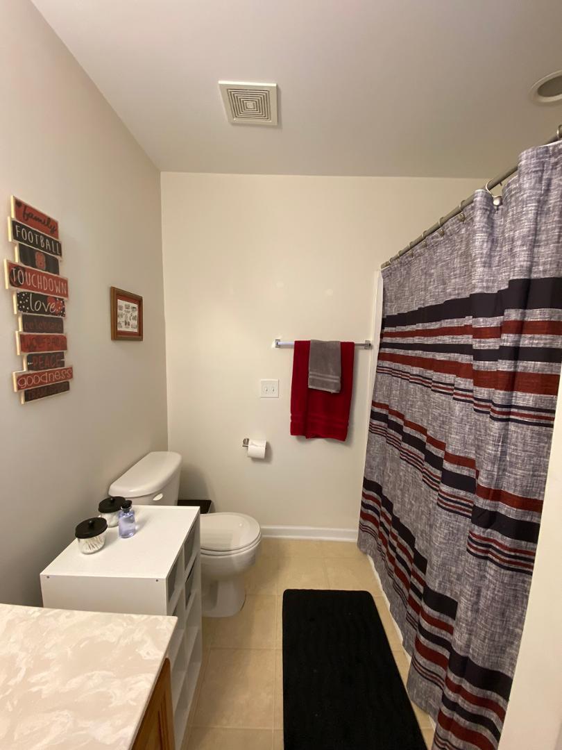 4646 Altha Street Raleigh, NC 27606 - Photo 20 of 23 a bathroom with a sink and a mirror