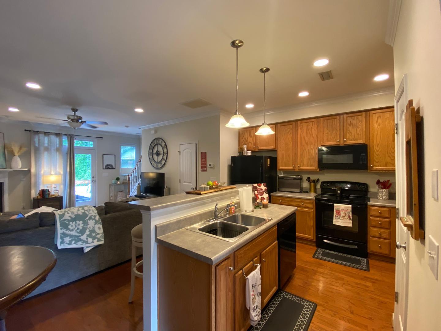 4646 Altha Street Raleigh, NC 27606 - Photo 5 of 23 a kitchen that has a lot of cabinets a sink and a counter top space