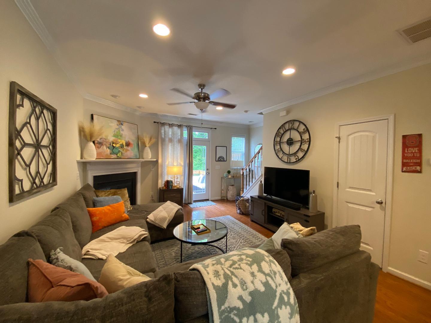 4646 Altha Street Raleigh, NC 27606 - Photo 7 of 23 a living room with furniture a fireplace and a flat screen tv