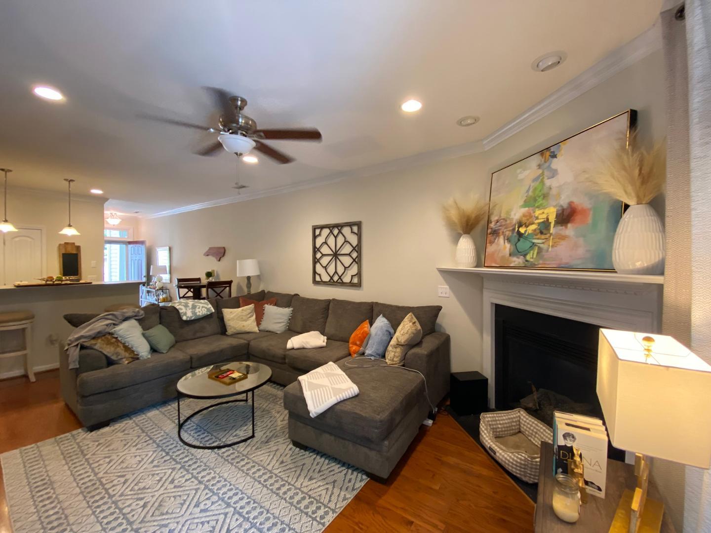 4646 Altha Street Raleigh, NC 27606 - Photo 8 of 23 a living room with furniture a rug and a fireplace