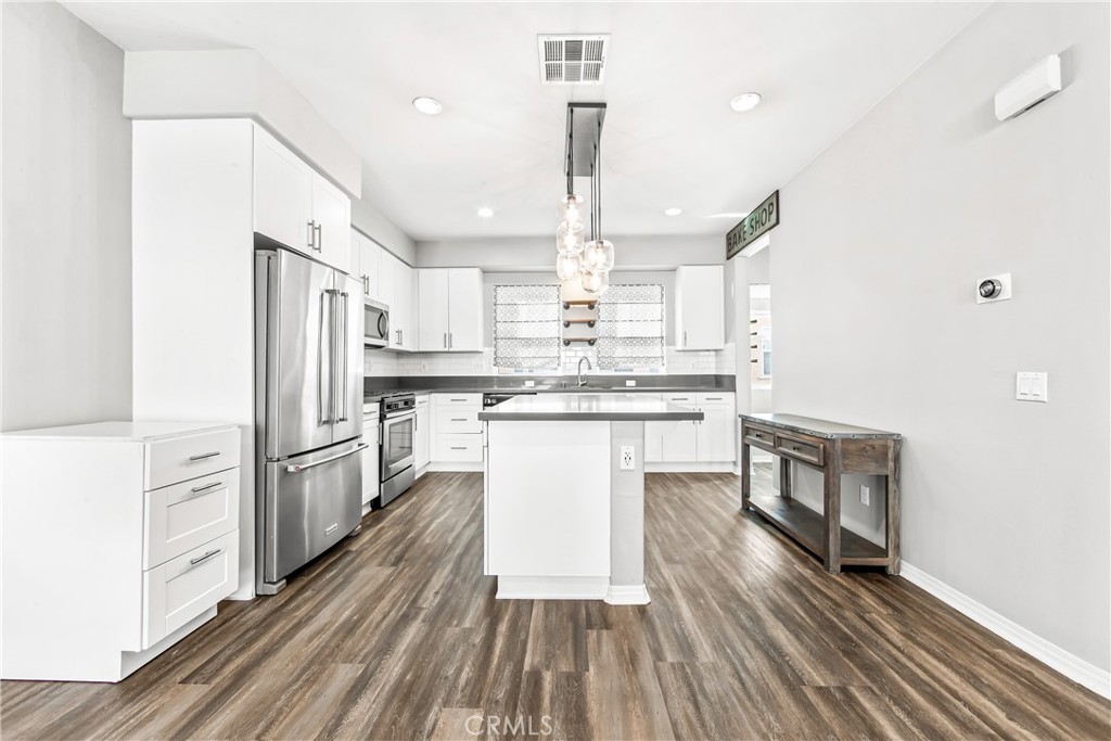 6331 Pacific Way Westminster, CA 92683 - Photo 4 of 38 a kitchen with stainless steel appliances a refrigerator a stove microwave and cabinets