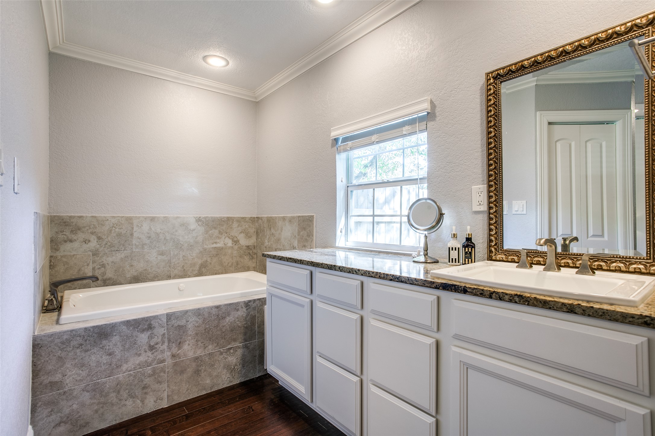332 Tuttle Road Terrell Hills, TX 78209 - Photo 17 of 25 a bathroom with a double vanity sink and mirror with bathtub