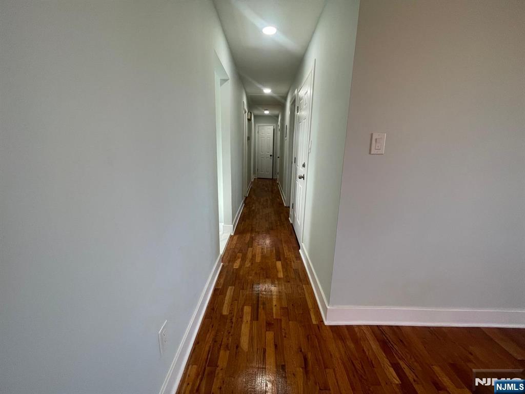 85 Grove Street, Unit 2 South Hackensack, NJ 07606 - Photo 4 of 8 a view of a hallway with wooden floor