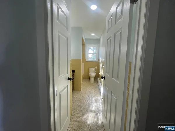 a view of a hallway with a livingroom and a chair
