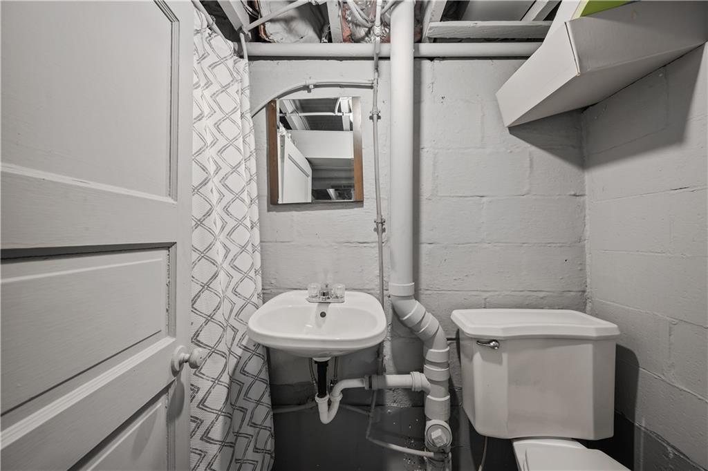 920 Watson Street Coraopolis, PA 15108 - Photo 25 of 36 a bathroom with a sink a toilet and mirror