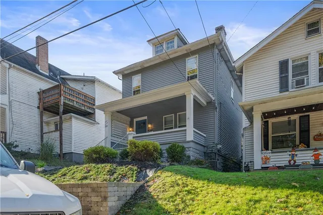 an aerial view of a houses with street