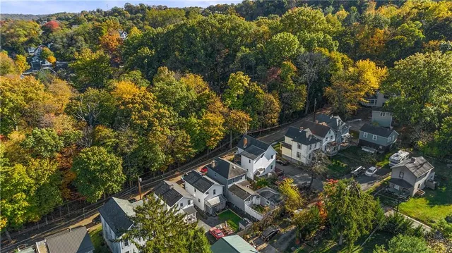an aerial view of a house with lots of trees
