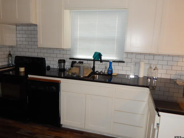 a kitchen with a sink and cabinets