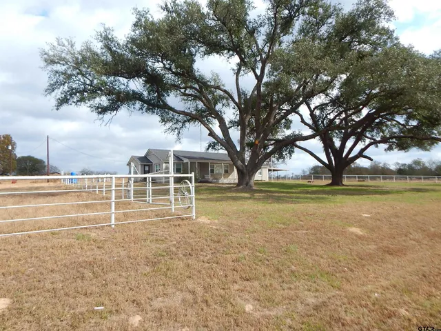 a view of a house with a yard and sitting area