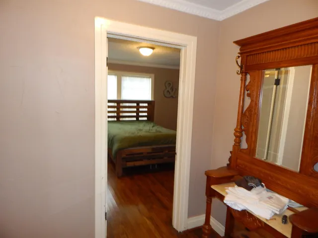 a view of a hallway and a livingroom with furniture