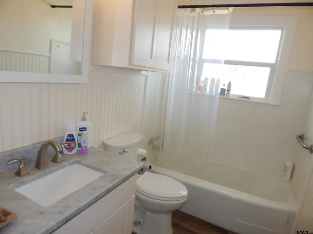 a bathroom with a sink toilet and tub