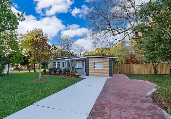 a front view of house with yard and green space