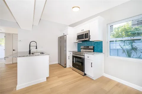 a kitchen with a sink stove and refrigerator