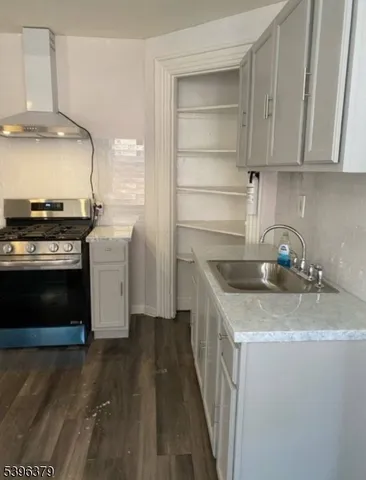 a kitchen with stainless steel appliances granite countertop a stove and a sink