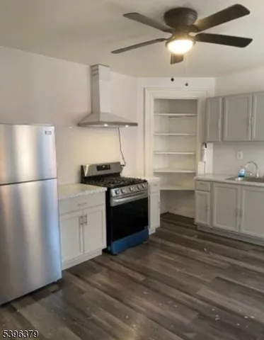a kitchen with granite countertop a refrigerator and a stove