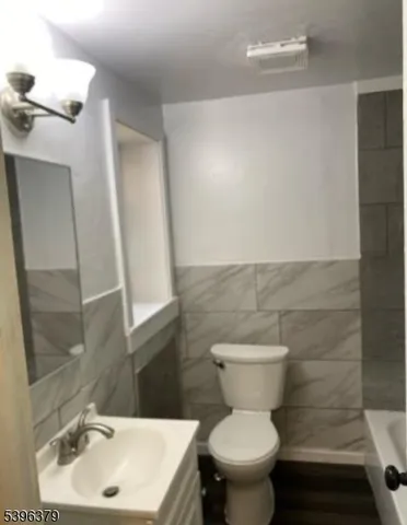 a bathroom with a sink toilet and a mirror