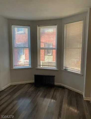a room with a window and a wooden floor