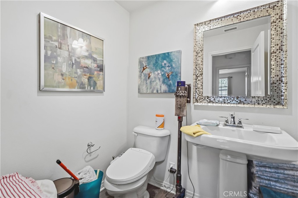 3380 Pine Ridge Loop Ontario, CA 91761 - Photo 15 of 37 a bathroom with a toilet a sink and mirror