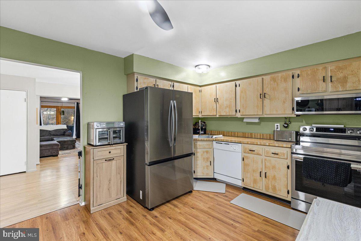 2116 Silver Court Hamilton, NJ 08690 - Photo 12 of 26 a kitchen with a refrigerator cabinets and wooden floor