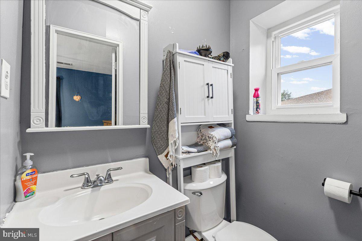 2116 Silver Court Hamilton, NJ 08690 - Photo 24 of 26 a bathroom with a sink mirror and toilet