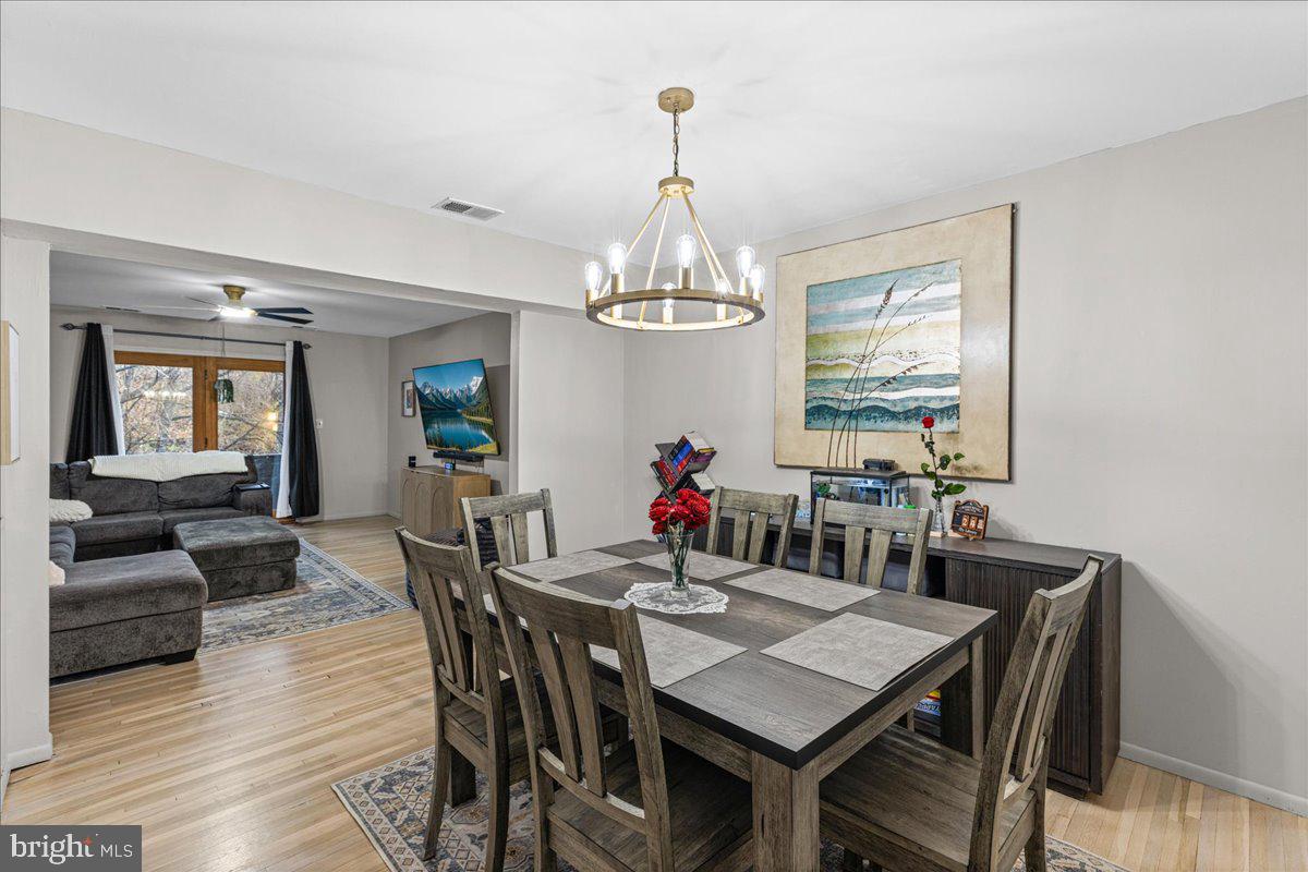 2116 Silver Court Hamilton, NJ 08690 - Photo 8 of 26 a view of a dining room with furniture wooden floor and chandelier