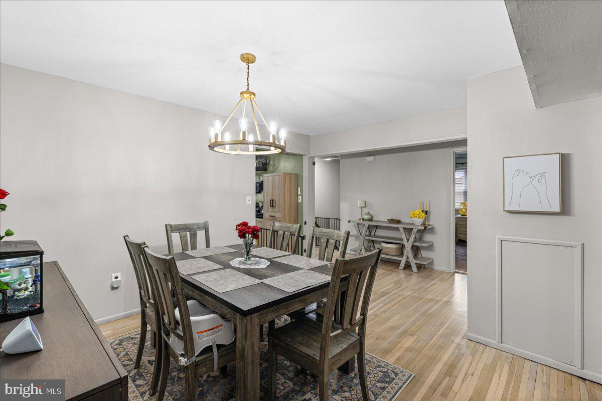 2116 Silver Court Hamilton, NJ 08690 - Photo 10 of 26 a view of a dining room with furniture wooden floor and chandelier