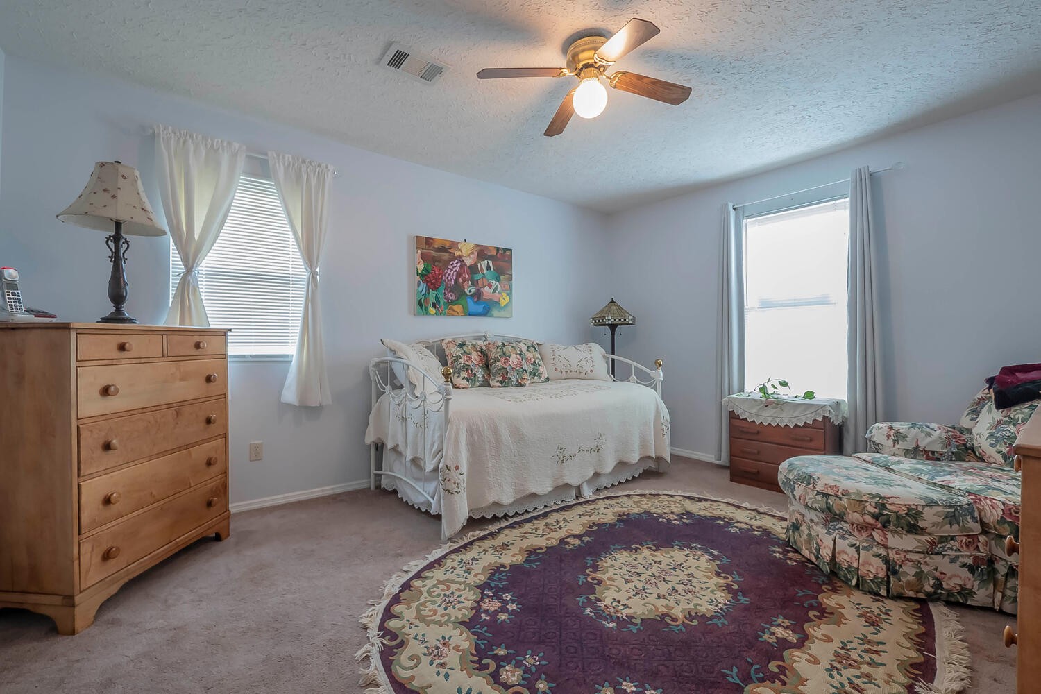 5970 Milton Fox Road Franklin, TN 37064 - Photo 21 of 49 a bedroom with a bed and a chandelier