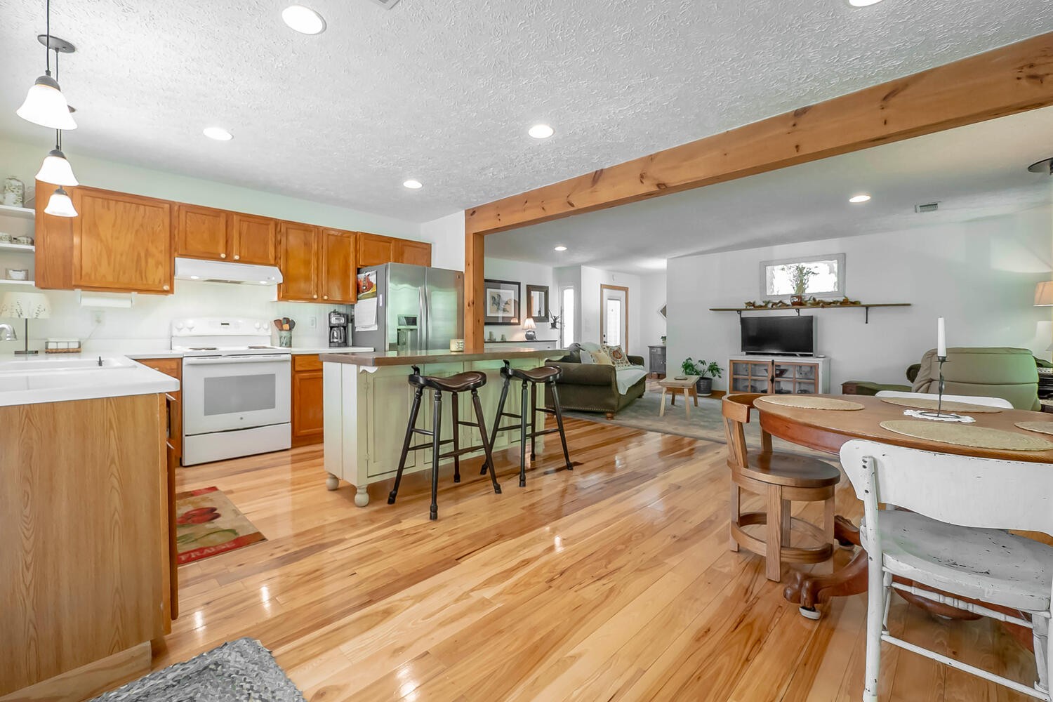 5970 Milton Fox Road Franklin, TN 37064 - Photo 10 of 49 a living room with stainless steel appliances kitchen island granite countertop furniture and a wooden floor