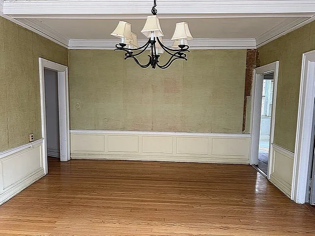 a view of a room with wooden floor and windows